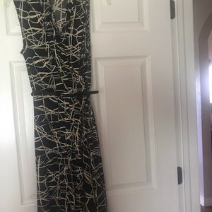 Button down the front dress. Black and Tan pattern with black skinny vinyl belt.